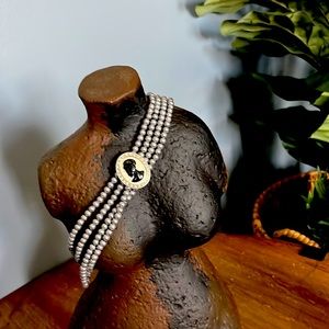 Vintage costume grey pearls. African woman cameo.